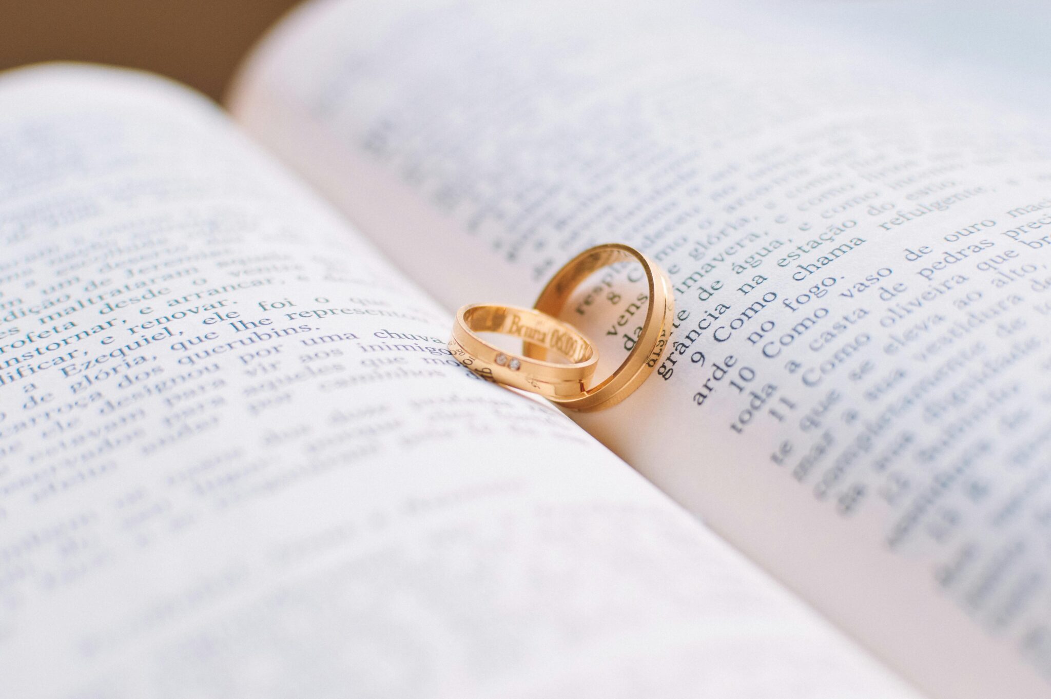 two gold rings on a book
